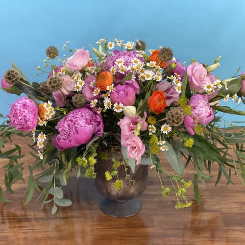 Pink peonies with chamomile and ranunculus in patina pedestal urn by best florist Raleigh